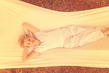 Image showing young woman resting on hammock