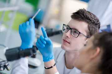 Image showing Group of young medical students doing research