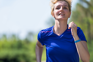 Image showing young female runner training for marathon