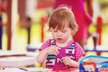 Image showing little girl drawing a colorful pictures