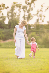 Image showing mother and little daughter playing at backyard