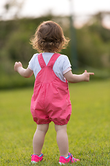 Image showing little girl spending time at backyard