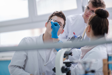 Image showing Group of young medical students doing research