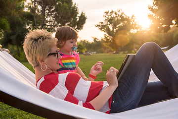 Image showing mom and a little daughter relaxing in a hammock