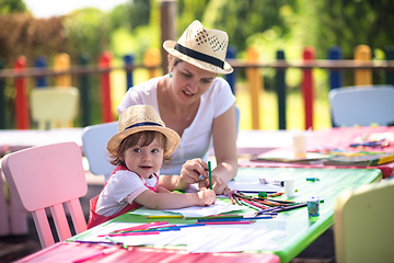 Image showing mom and little daughter drawing a colorful pictures