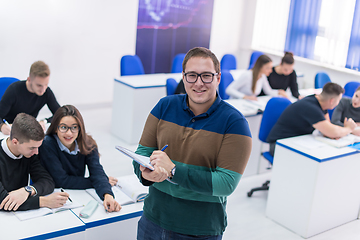 Image showing male student with others writing notes