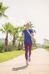 Image showing young female runner training for marathon