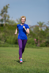 Image showing young female runner training for marathon