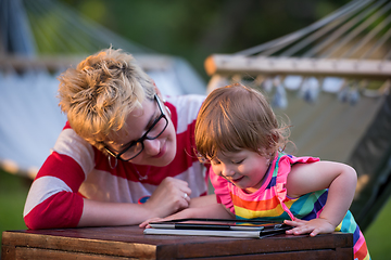 Image showing mom and her little daughter using tablet computer