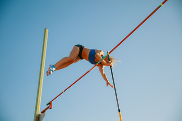 Image showing Female high jumper training at the stadium in sunny day