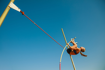 Image showing Female high jumper training at the stadium in sunny day