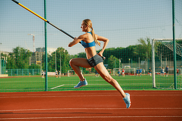 Image showing Female high jumper training at the stadium in sunny day