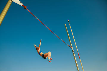 Image showing Female high jumper training at the stadium in sunny day