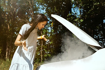 Image showing Young woman traveling on the car in sunny day