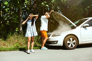 Image showing Young couple traveling on the car in sunny day