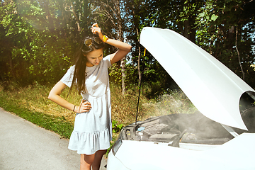 Image showing Young woman traveling on the car in sunny day