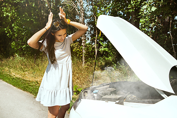 Image showing Young woman traveling on the car in sunny day