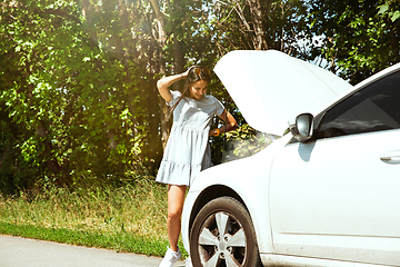 Image showing Young woman traveling on the car in sunny day