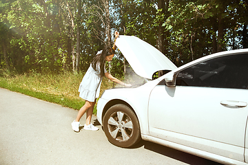 Image showing Young woman traveling on the car in sunny day