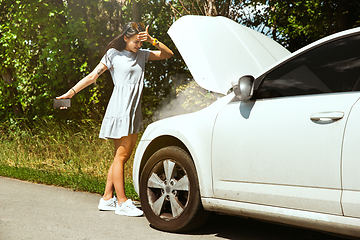 Image showing Young woman traveling on the car in sunny day