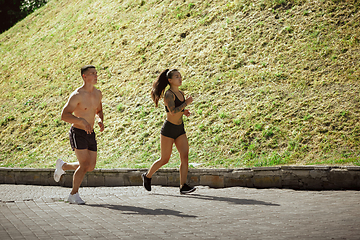 Image showing A muscular athletes doing workout on the city\'s street or park