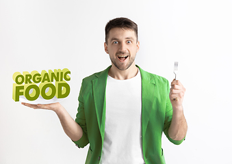 Image showing Food concept. Model holding a plate with letters of Organic food