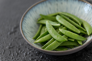 Image showing peas in bowl on wet slate stone background