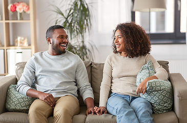 Image showing happy african american couple on sofa at home