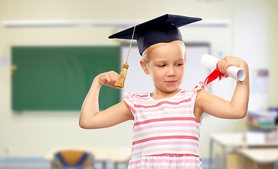 Image showing little girl in mortarboard with diploma at school