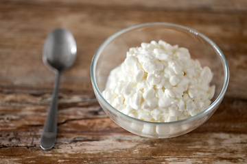 Image showing close up of cottage cheese in bowl on wooden table