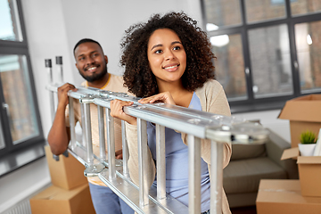 Image showing happy couple with ladder moving to new home