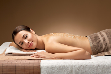 Image showing woman lying with sea salt on skin at spa