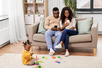 Image showing african baby girl playing with toy blocks at home