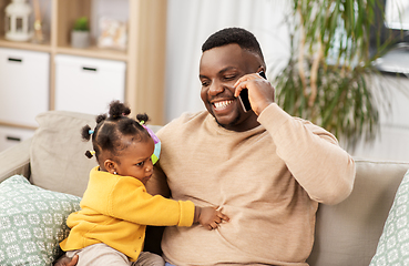 Image showing father with baby at home calling on smartphone