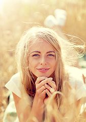 Image showing happy woman or teen girl lying in cereal field