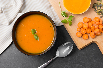 Image showing vegetable pumpkin cream soup in bowl with spoon