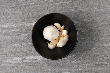 Image showing garlic in bowl on slate stone background