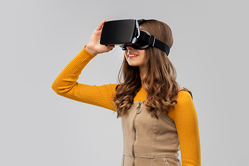 Image showing teenage girl in vr glasses over grey background