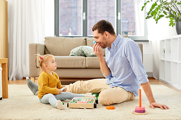 Image showing father playing with little baby daughter at home