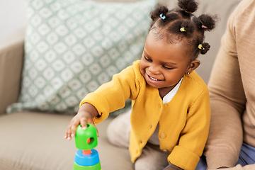 Image showing african family playing with baby daughter at home