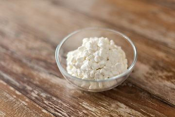 Image showing close up of cottage cheese in bowl on wooden table