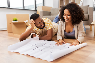 Image showing couple with boxes and blueprint moving to new home