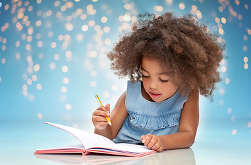 Image showing happy little african american girl with sketchbook