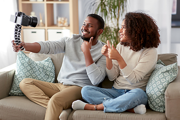 Image showing couple of video bloggers with camera at home