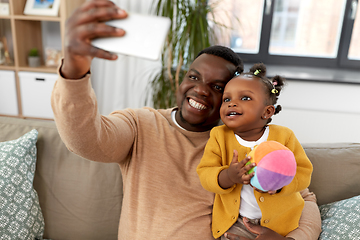 Image showing happy father with baby taking selfie at home