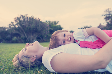 Image showing mother and little daughter playing at backyard