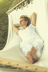 Image showing young woman resting on hammock