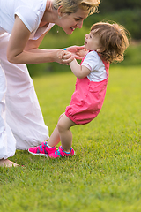 Image showing mother and little daughter playing at backyard