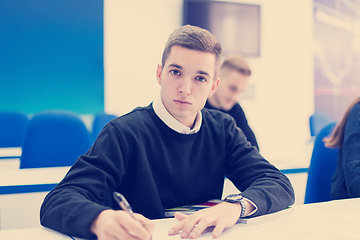 Image showing male student writing notes