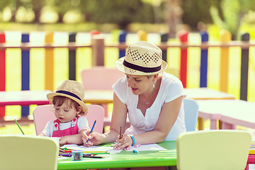 Image showing mom and little daughter drawing a colorful pictures